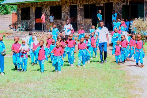 Pupils walking across the field with a teacher