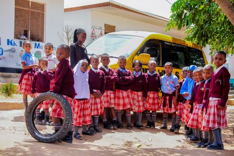 Pupils gathered beside the yellow Jupe Hills school van