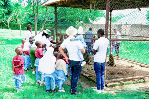 Pupils and staff gathered at a shelter on a school trip